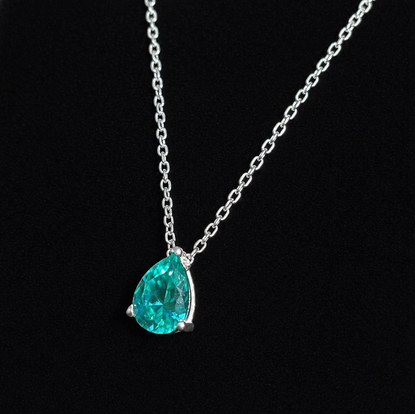 Paraiba Tourmaline Pear Cut Pendant Necklace on a black background