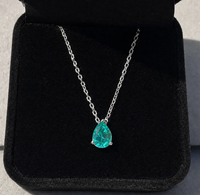 Paraiba Tourmaline Pear Cut Pendant Necklace on a black background