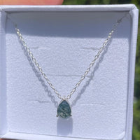 Moss agate necklace on a white background