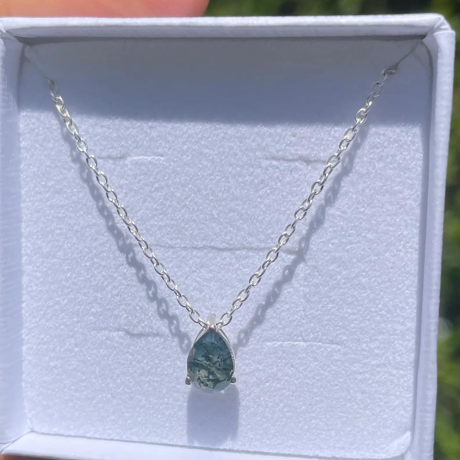 Moss agate necklace on a white background